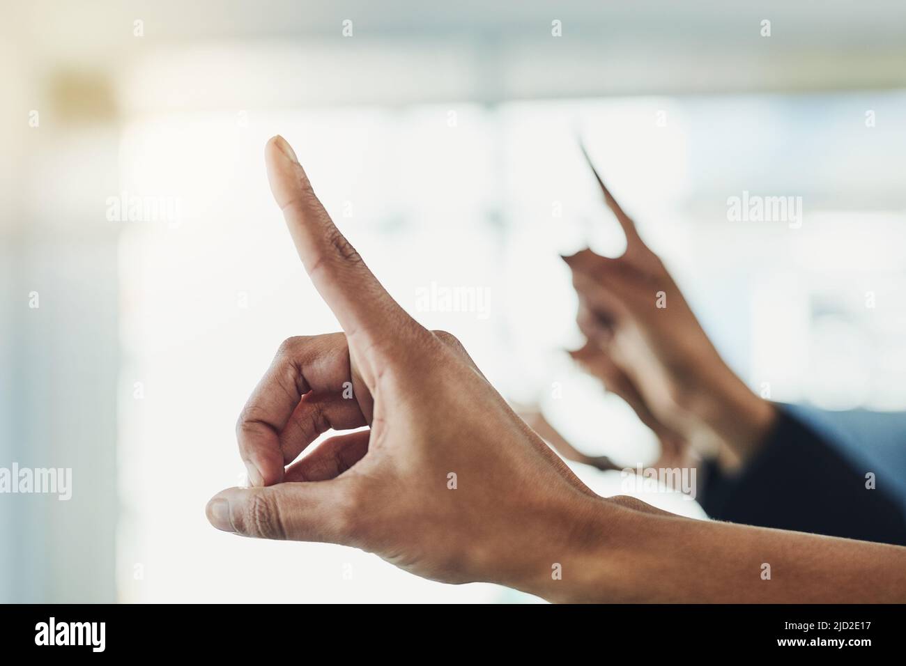 Just a few questions. Closeup shot of unrecognizable people raising their hands to ask a question. Stock Photo