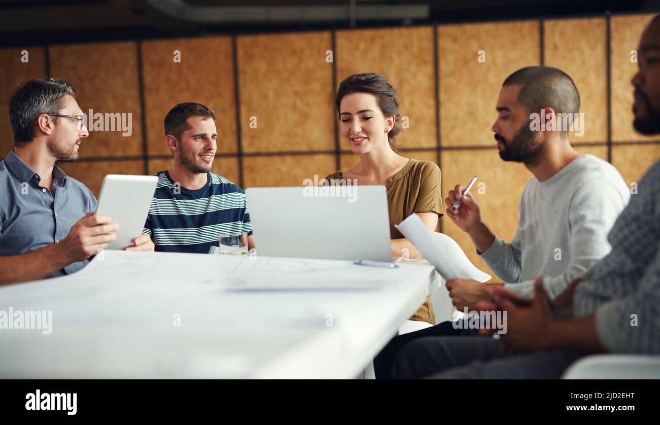 Theyll come up with the best way forward. Shot of a group of coworkers having a meeting in an open plan office. Stock Photo