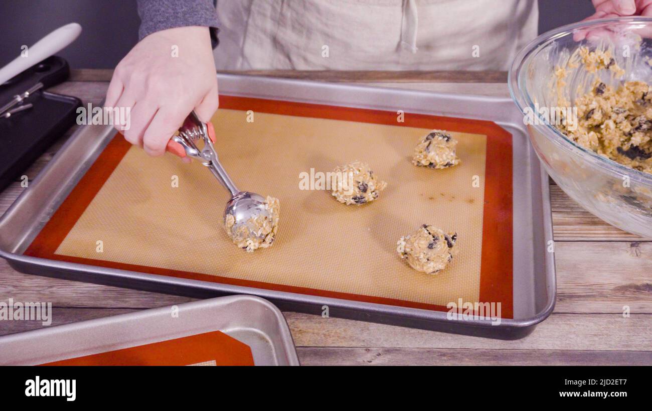 Step by step. Scooping cookie dough with a dough scoop into the baking