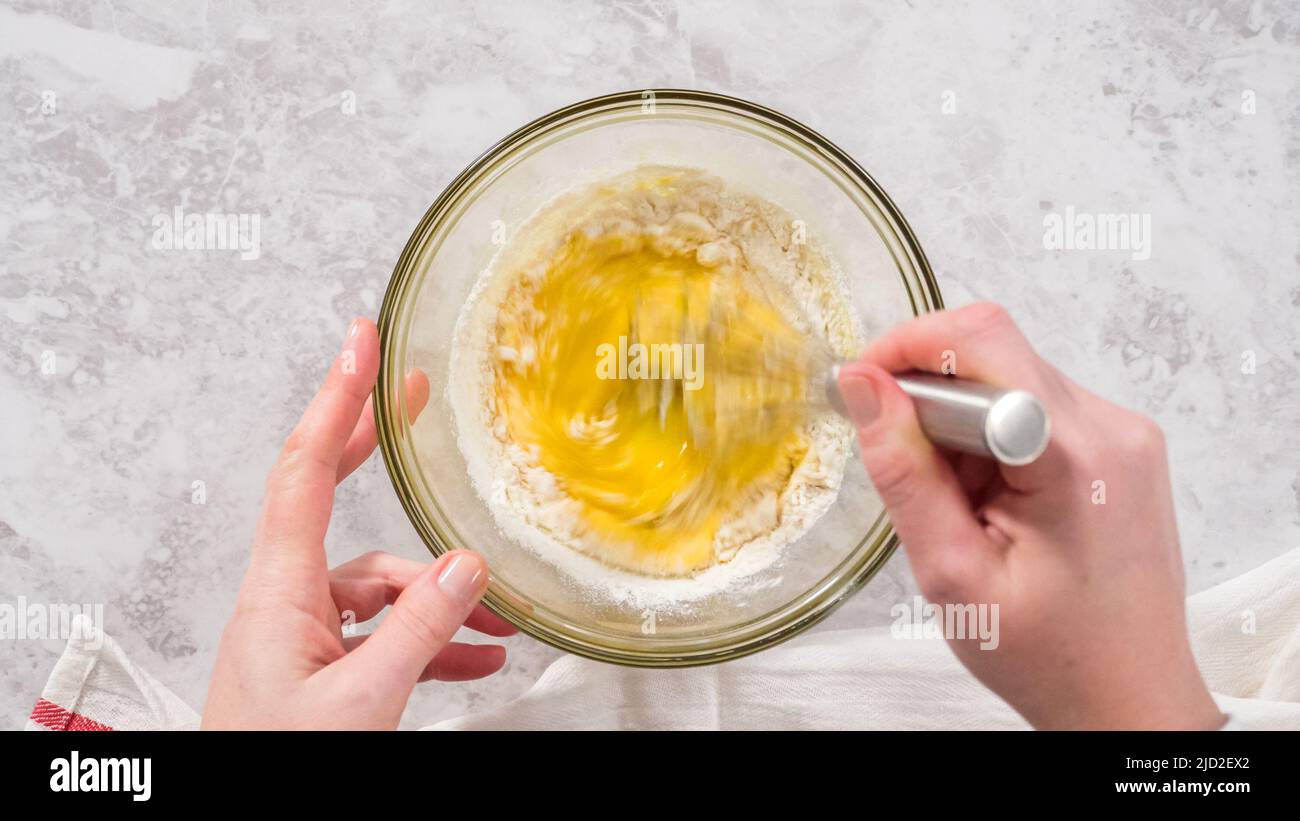 Flat lay. Step by step. Mixing ingredients in a glass mixing bowl to