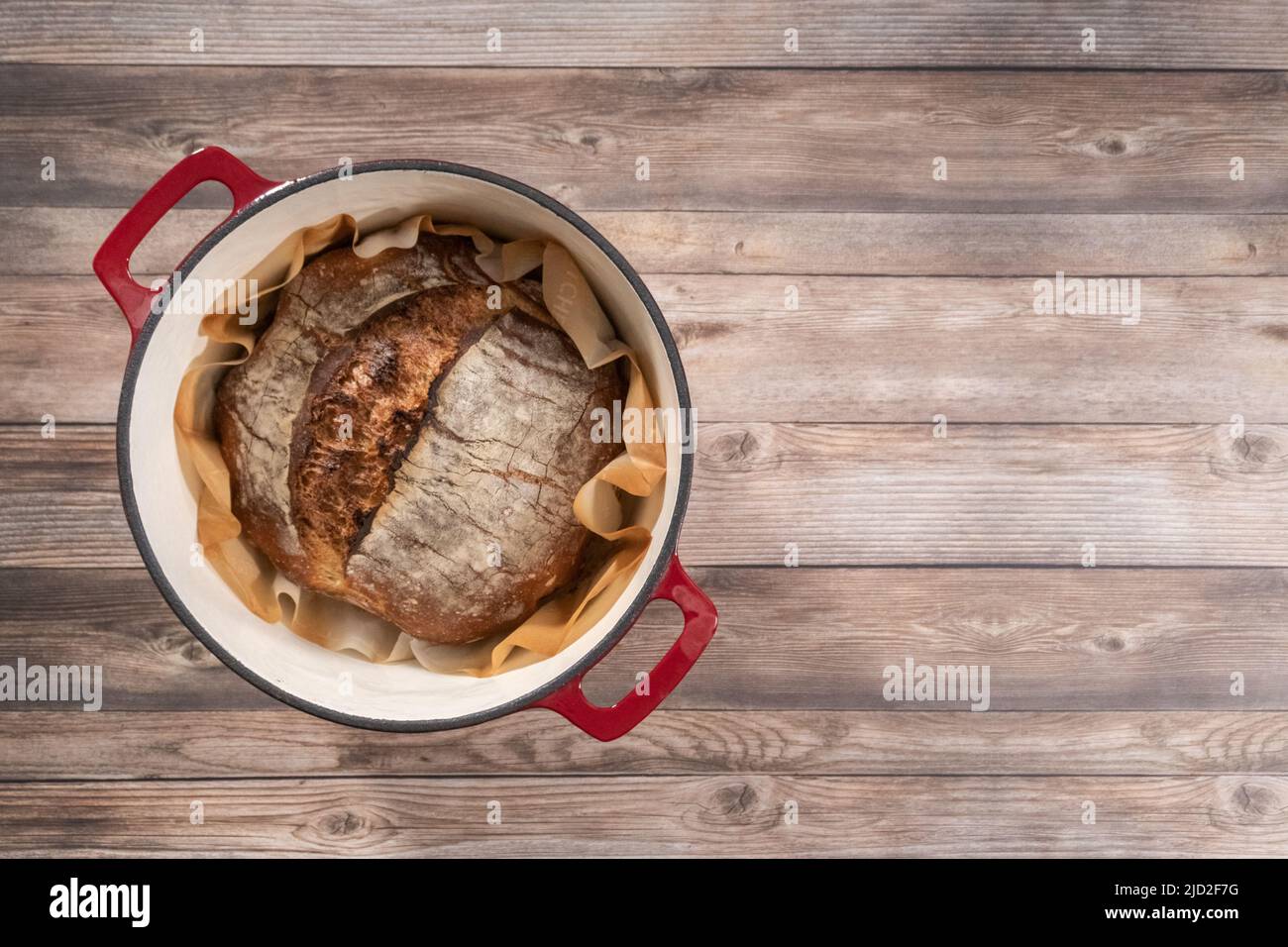 Flat lay. Freshly baked sourdough rye loaf of bread in a dutch oven