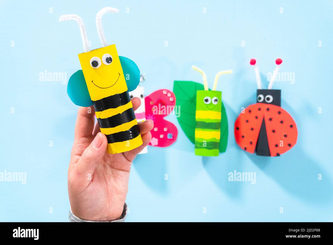Papercraft project. Colorful bugs made out of empty toilet rolls Stock