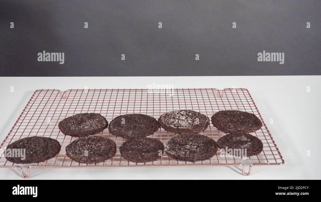 Step by step. Cooling freshly baked chocolate cookies on a wire rack ...