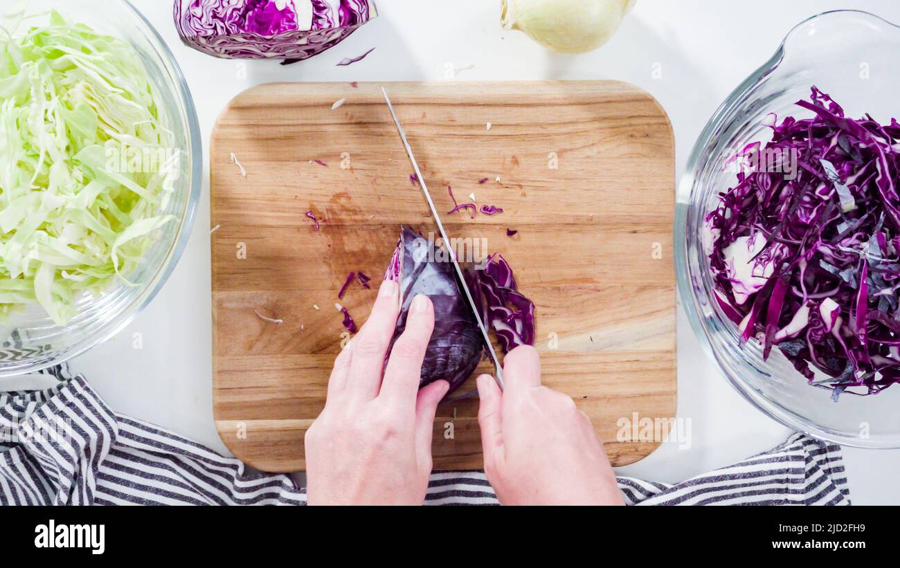Flat lay. Step by step. Shredding organic cabbage on a wood cutting