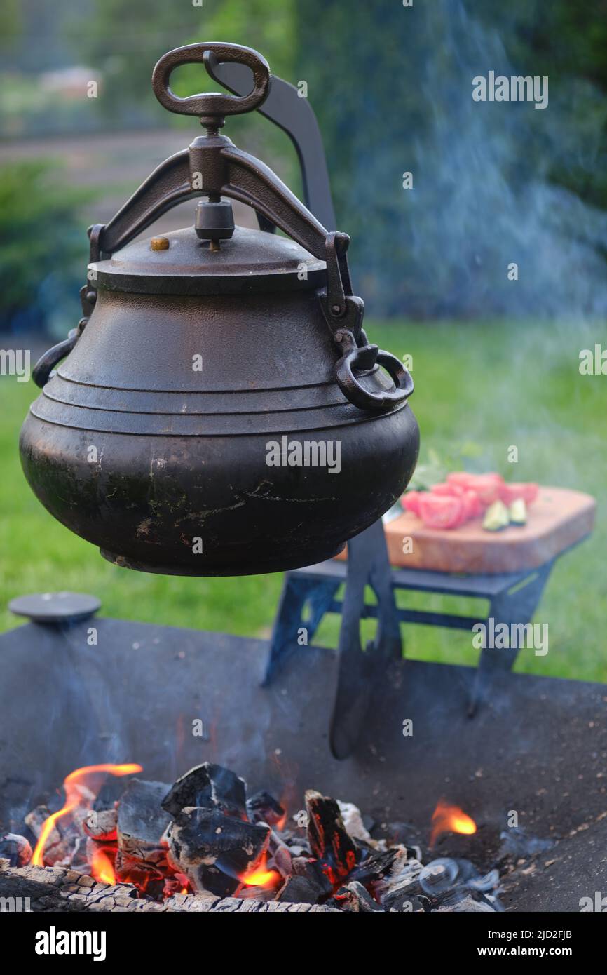 Cast iron pot over the fire outdoors Stock Photo Alamy