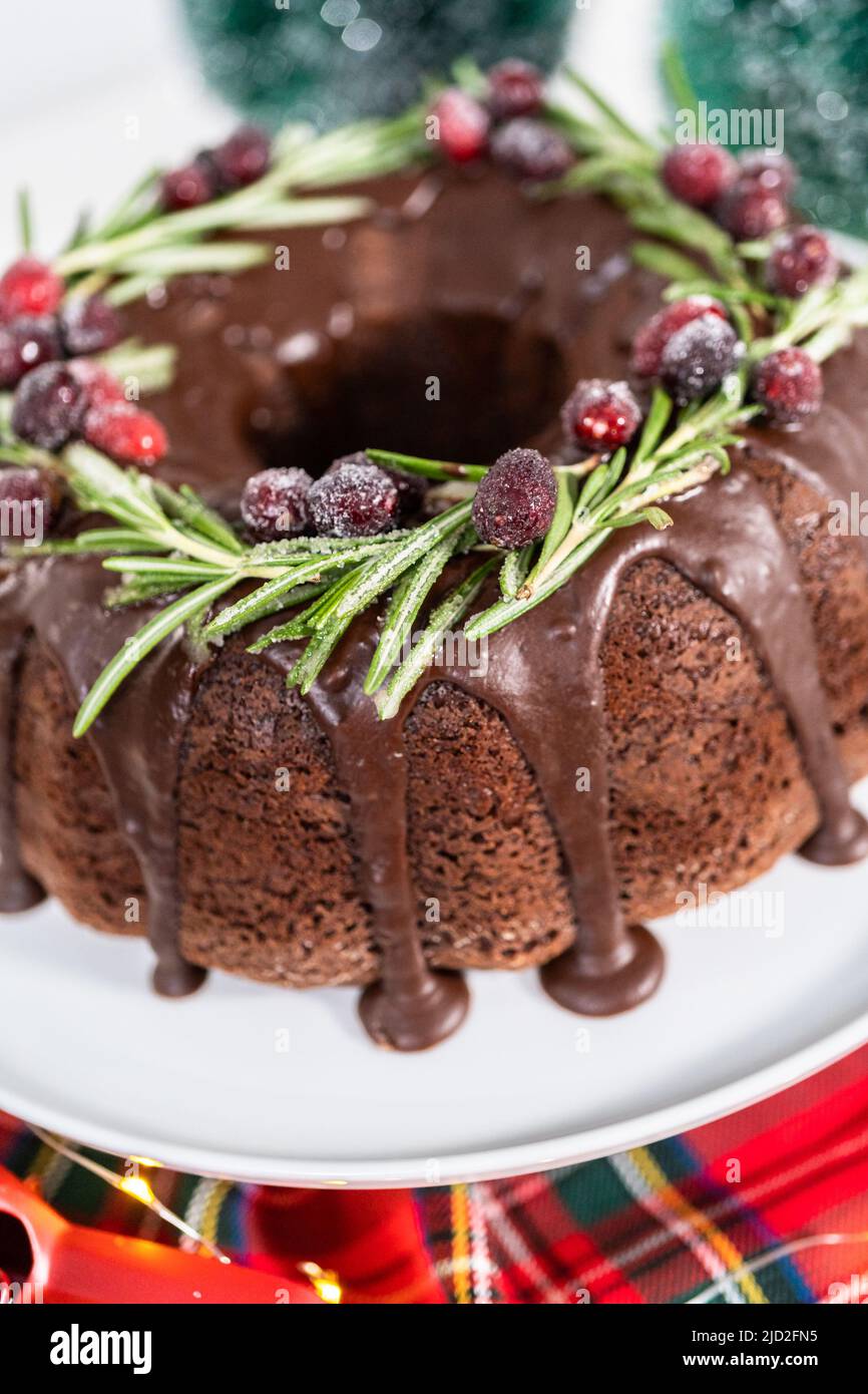Chocolate bundt cake with chocolate frosting decorated with fresh