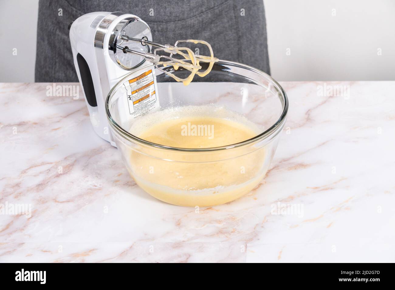 https://c8.alamy.com/comp/2JD2G7D/mixing-ingredients-in-a-large-glass-mixing-bowl-to-bake-apple-sharlotka-muffin-2JD2G7D.jpg