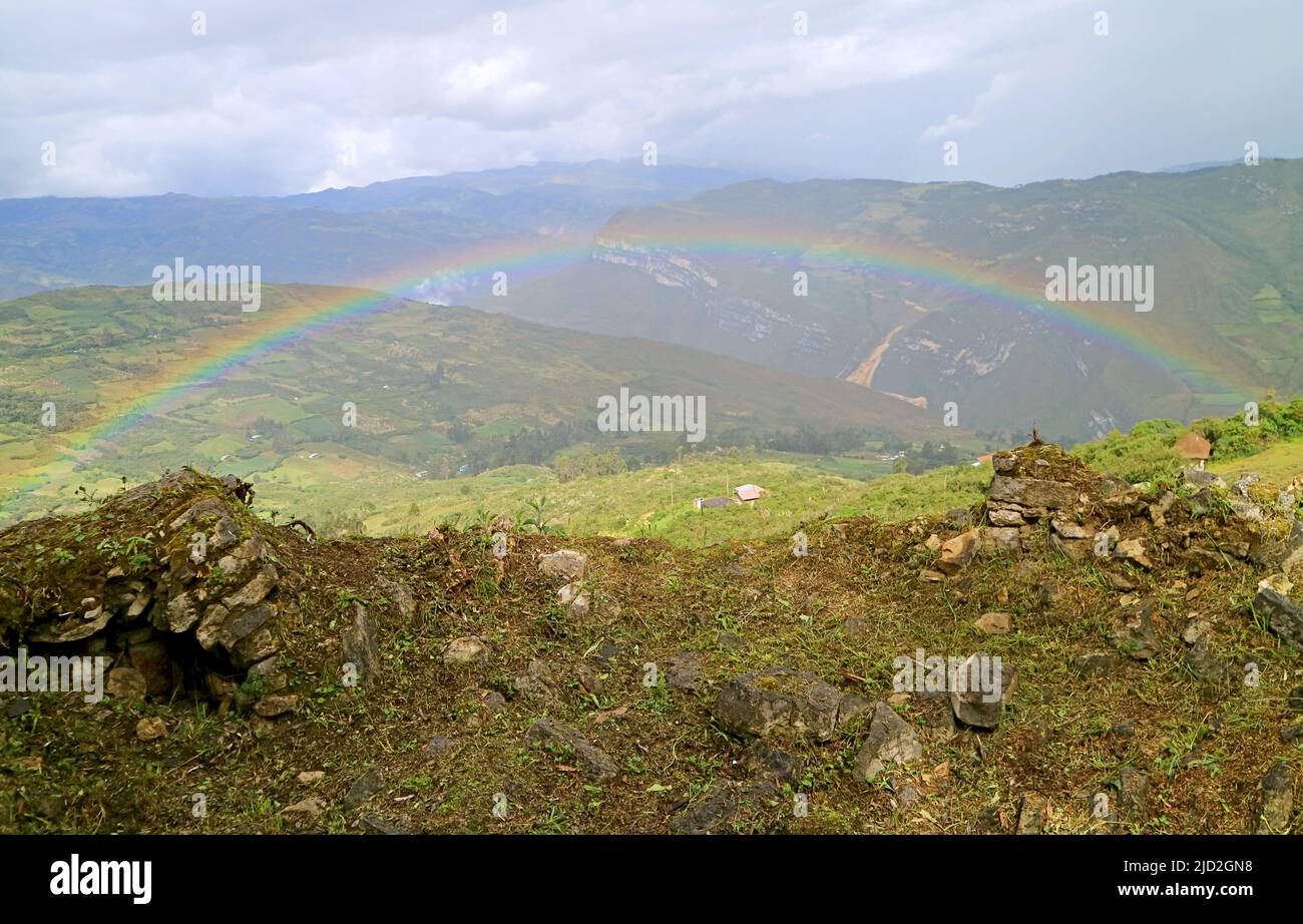 Amazing rainbow over the highland valley view from Kuelap ancient citadel in Amazonas region, northern Peru, South America Stock Photo
