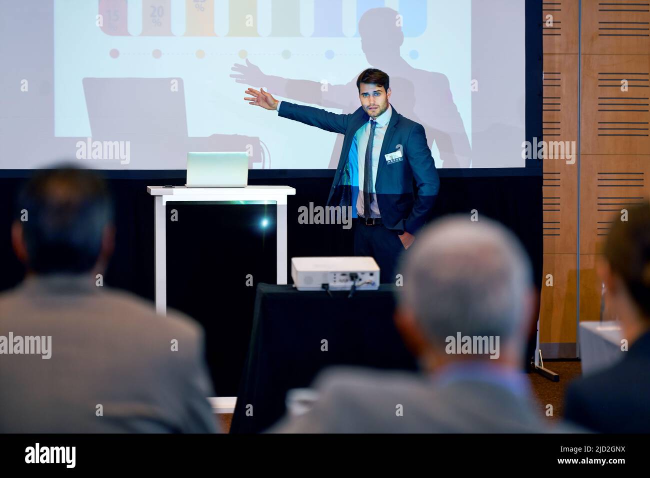Making presenting look good. A handsome businessman gesturing while