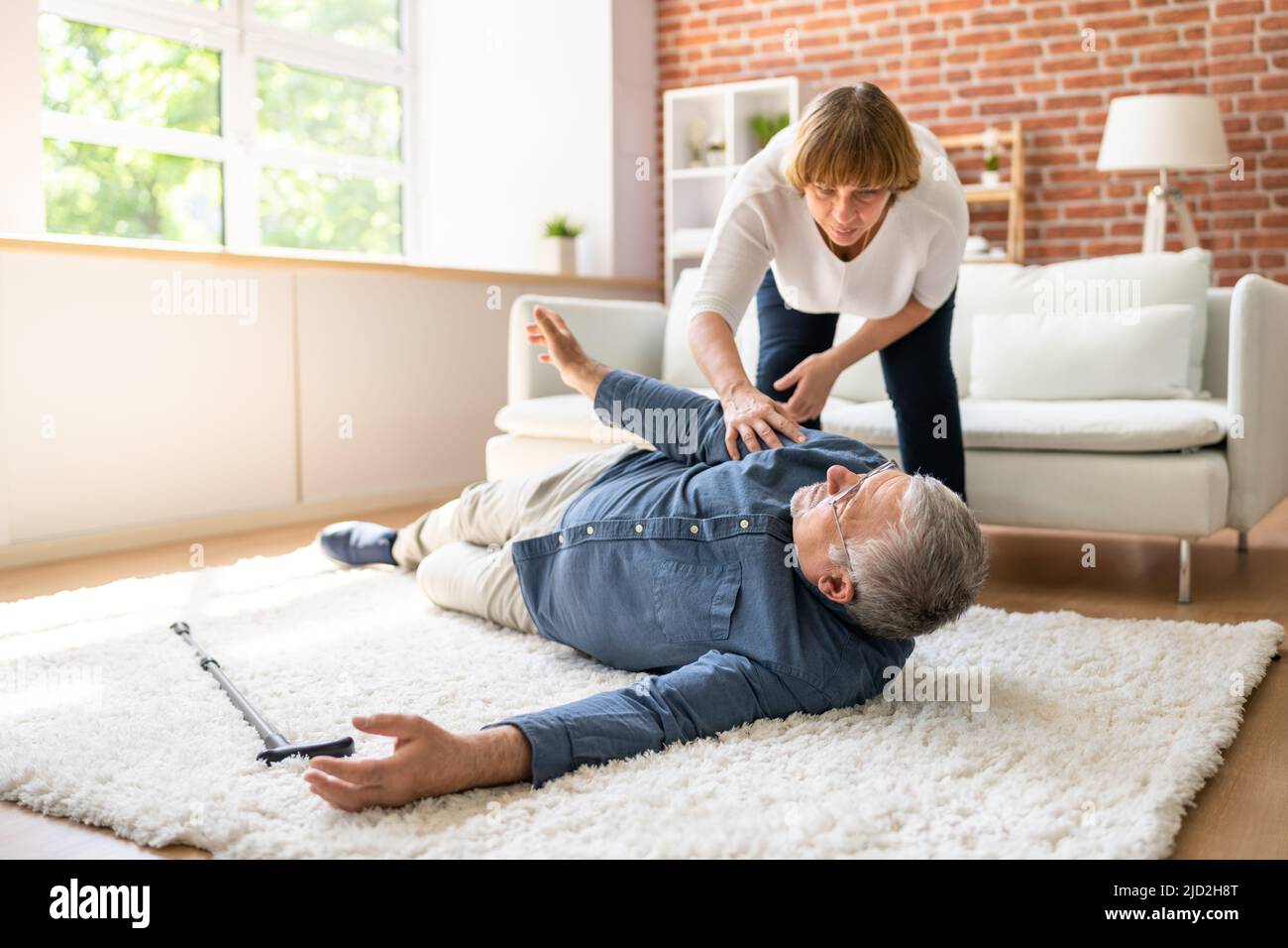 Slip And Fall Risk. Helping  Woman Stock Photo