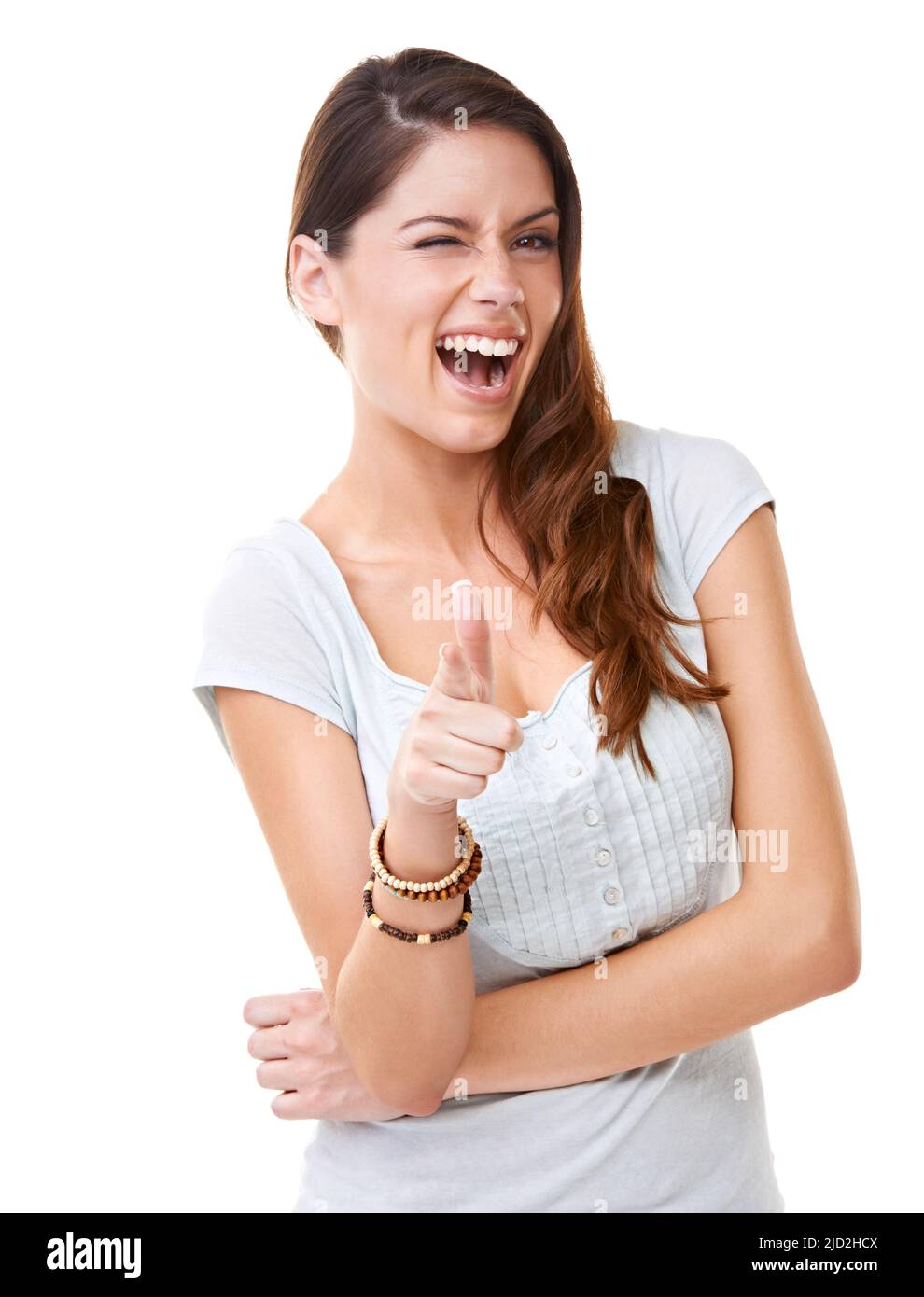 I like you. A beautiful young woman winking and pointing at the camera. Stock Photo