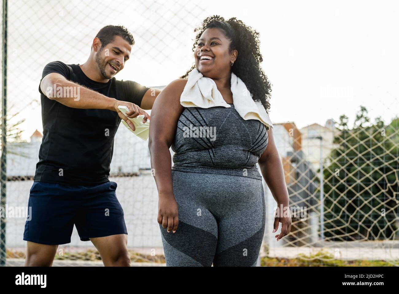 Personal trainer working with curvy woman - Sport people lifestyle concept Stock Photo