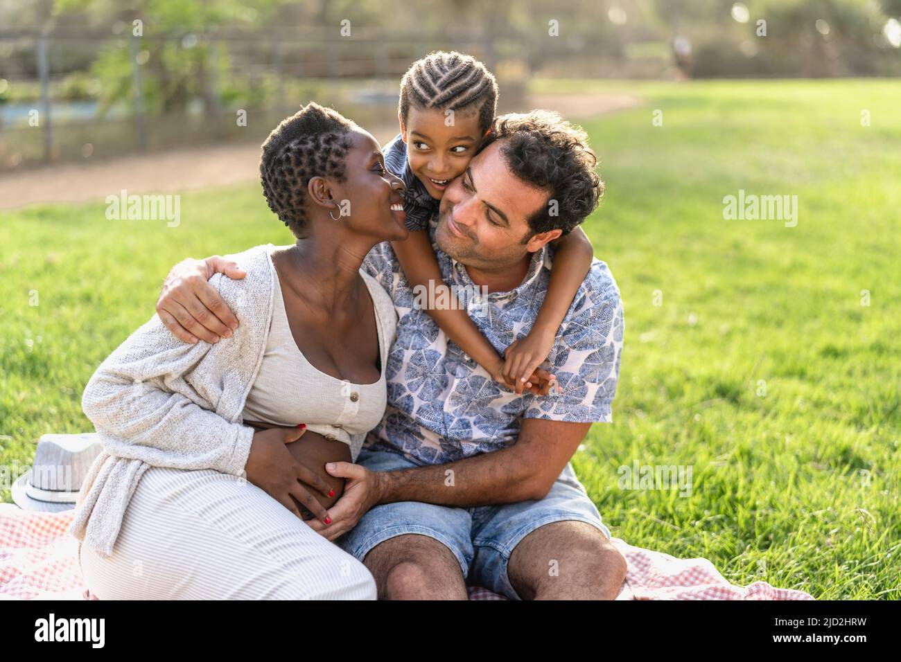 Happy multiracial family having fun together in the park Stock Photo