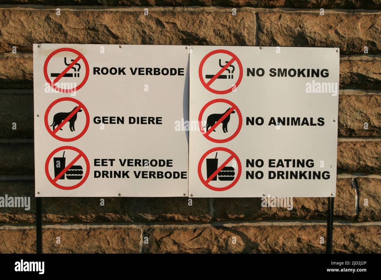 Forbidden signs in english and afrikaans on wall in the Voortrekker