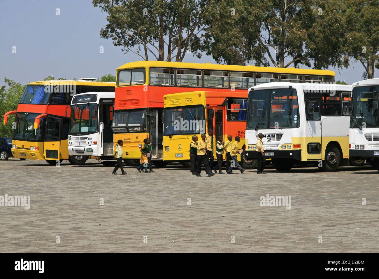 School and other buses in parking lot at the front of the Apartheid Museum, Johannesburg, Gauteng, South Africa. Stock Photo