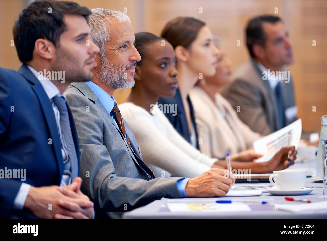 Recording the facts. Shot of a group of people sitting in a conference ...