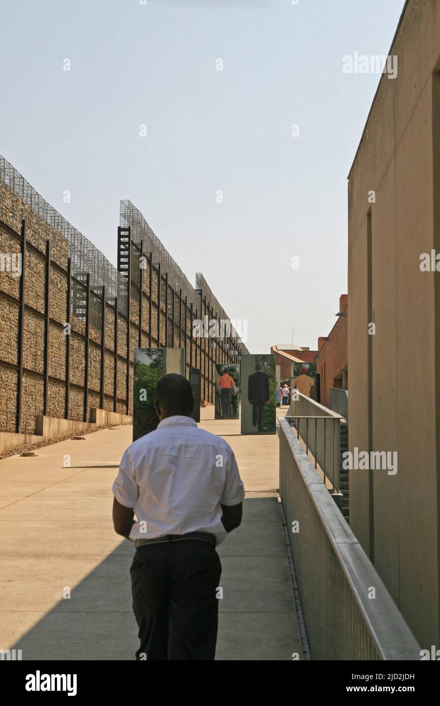 Exhibit mirrors within wall of outdoor Apartheid Museum, Johannesburg