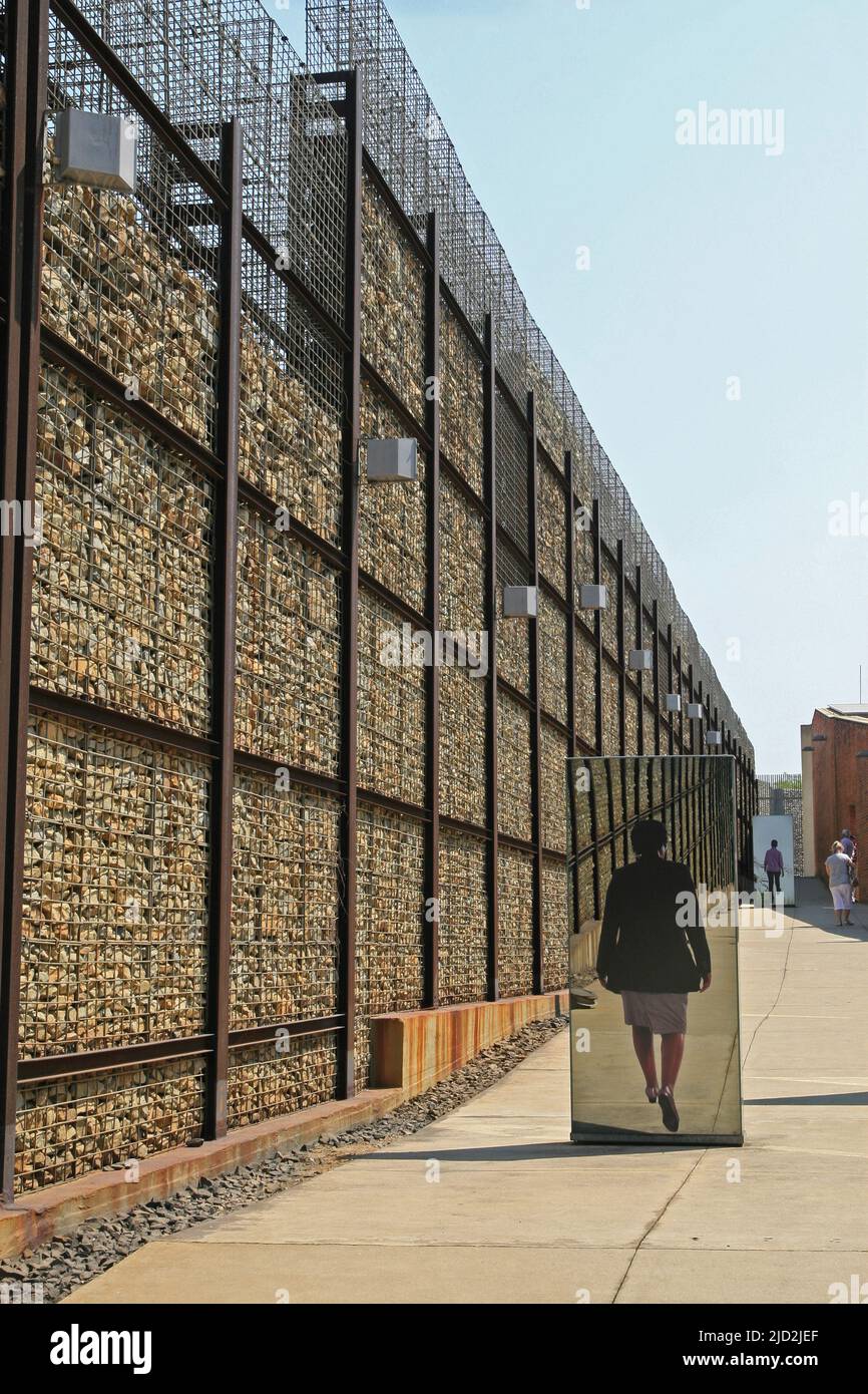 Exhibit mirrors within wall of outdoor Apartheid Museum, Johannesburg