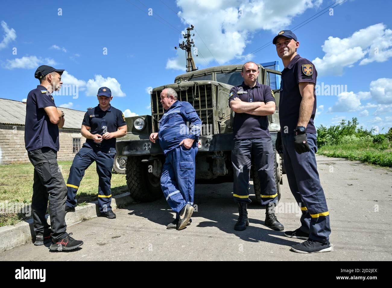 ZAPORIZHZHIA REGION, UKRAINE JUNE 16, 2022 Rescuers stand in front of a truck with diesel