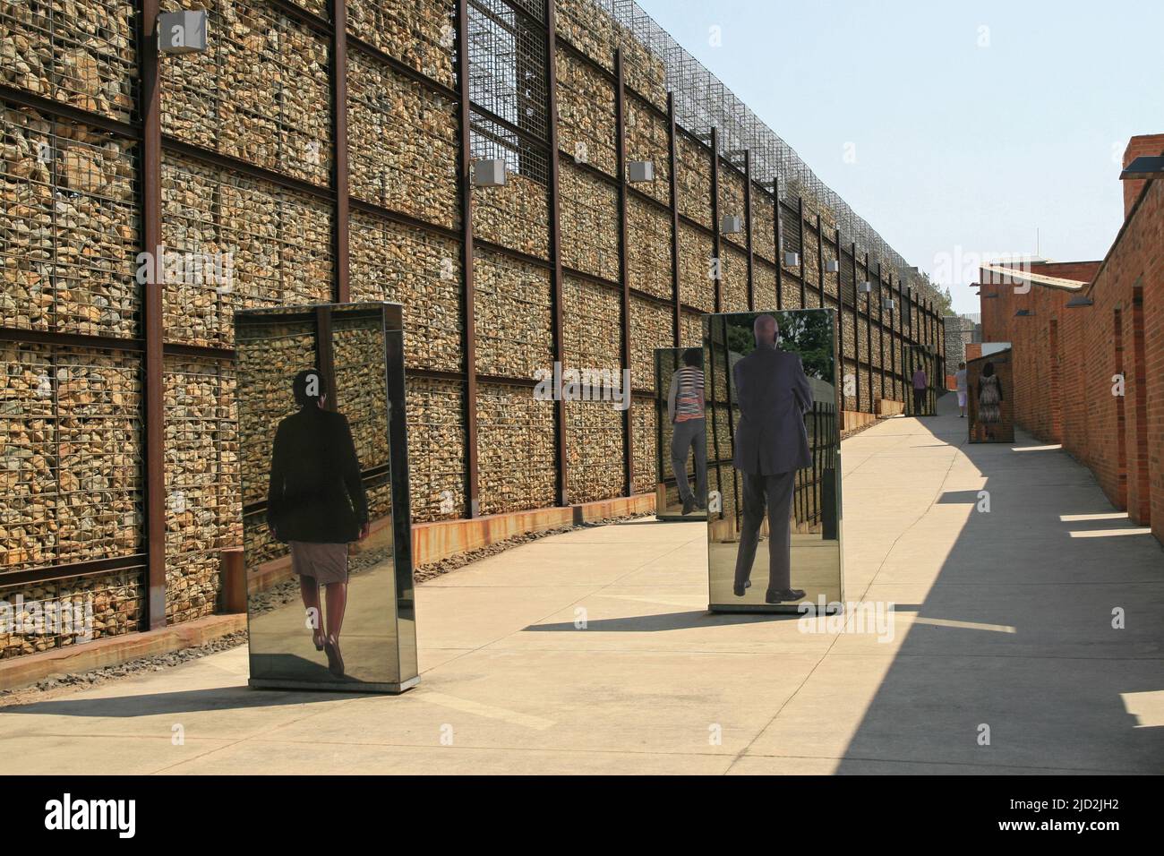 Exhibit mirrors within wall of outdoor Apartheid Museum, Johannesburg