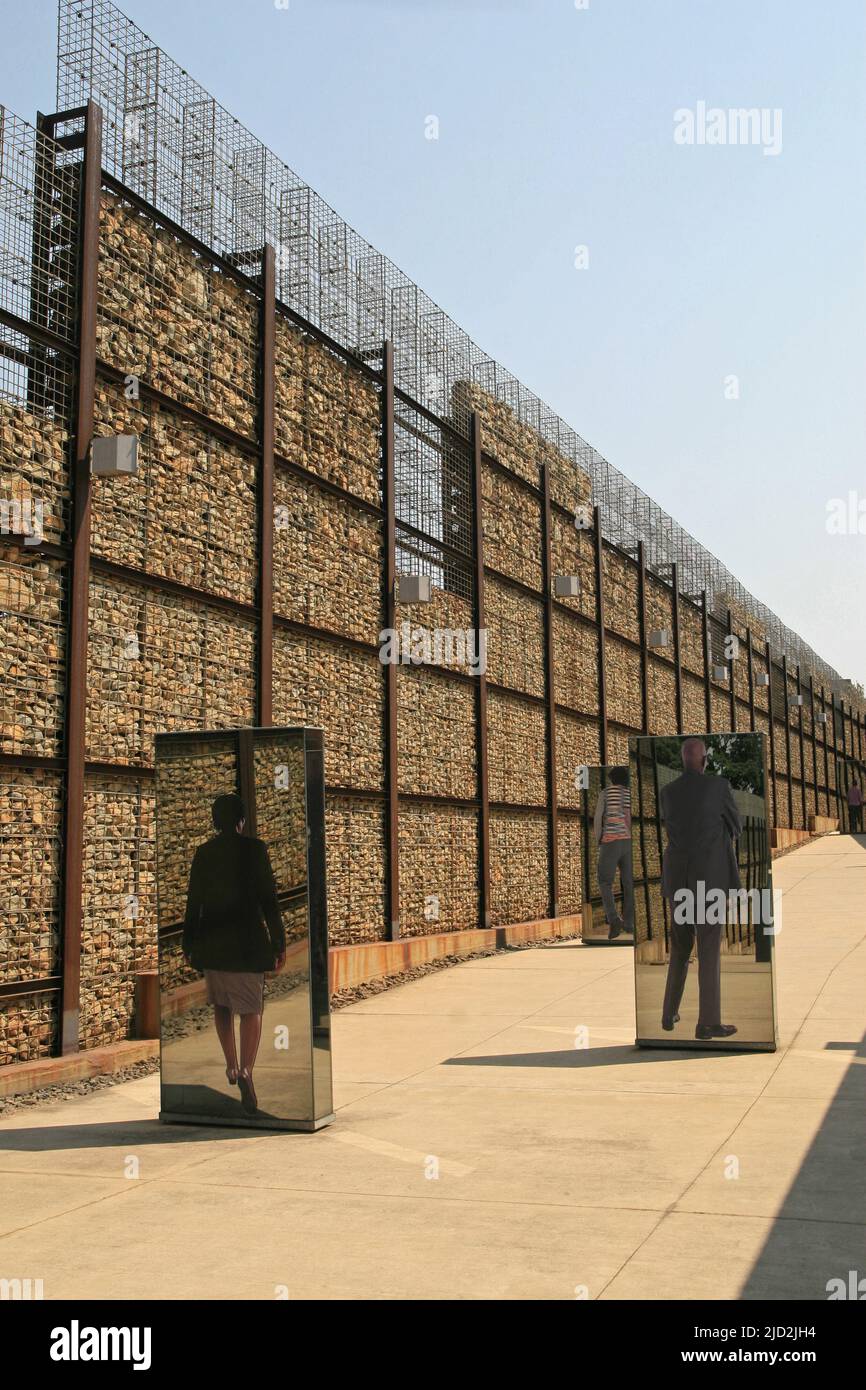 Exhibit mirrors within wall of outdoor Apartheid Museum, Johannesburg