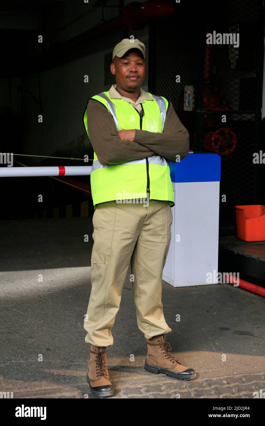 Security guard in front of automatic traffic boom gate, Braamfontein