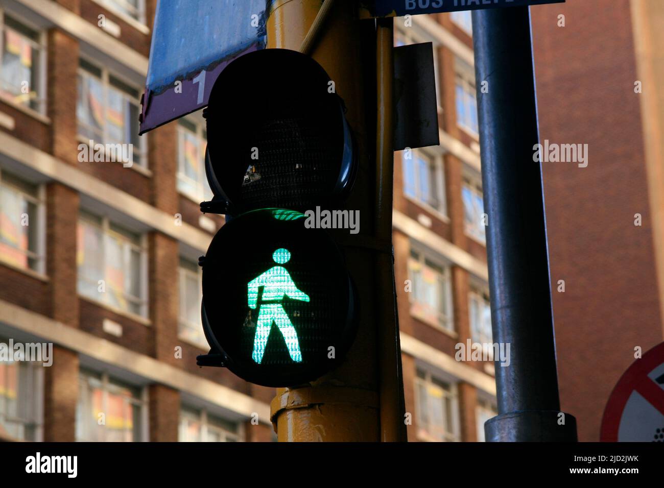 Pedestrian traffic light on green go light at pedestrian crossing