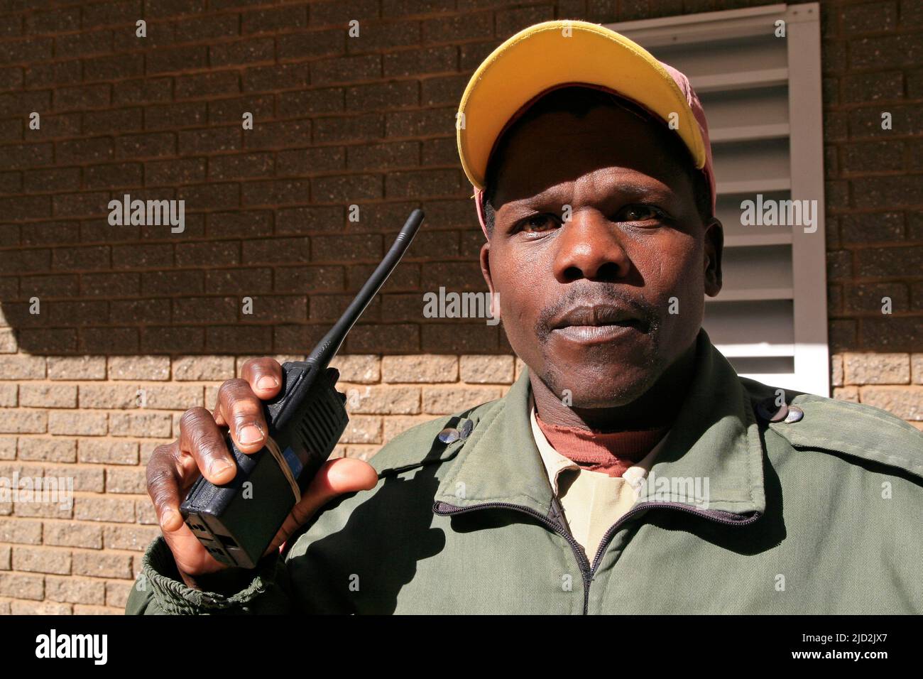 Security guard with walkie talkie 2-way radio, Braamfontein, Johannesburg, Gauteng, South Africa. Stock Photo