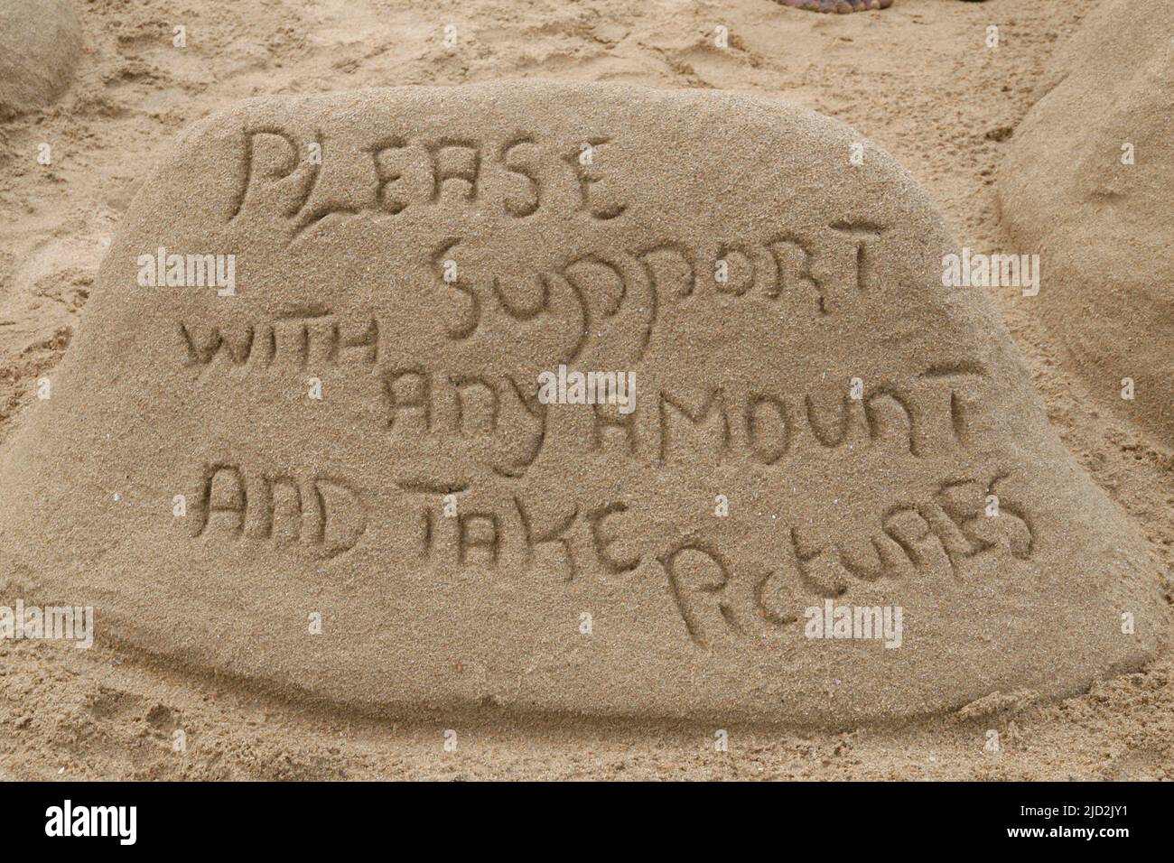 Sand sculpture 'Please support with any amount and take pictures', Umfolozi Beach, KwaZulu Natal, South Africa. Stock Photo