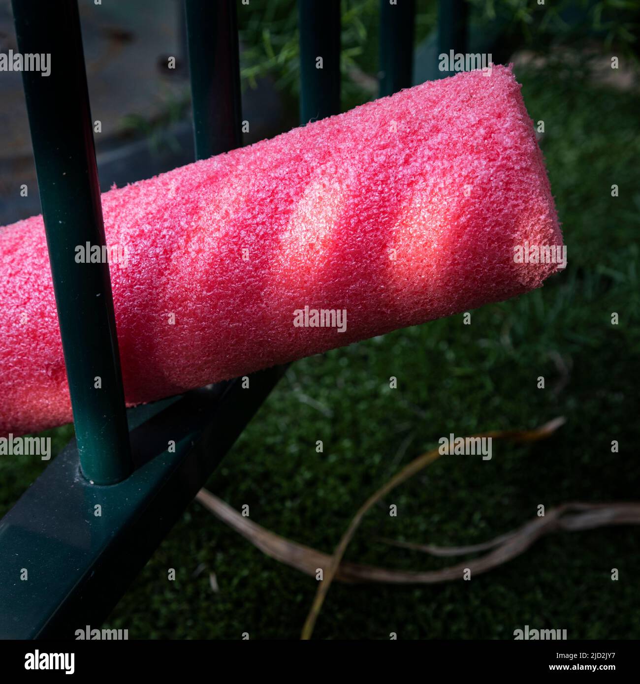 red pool noodle in pool fence and light Stock Photo Alamy