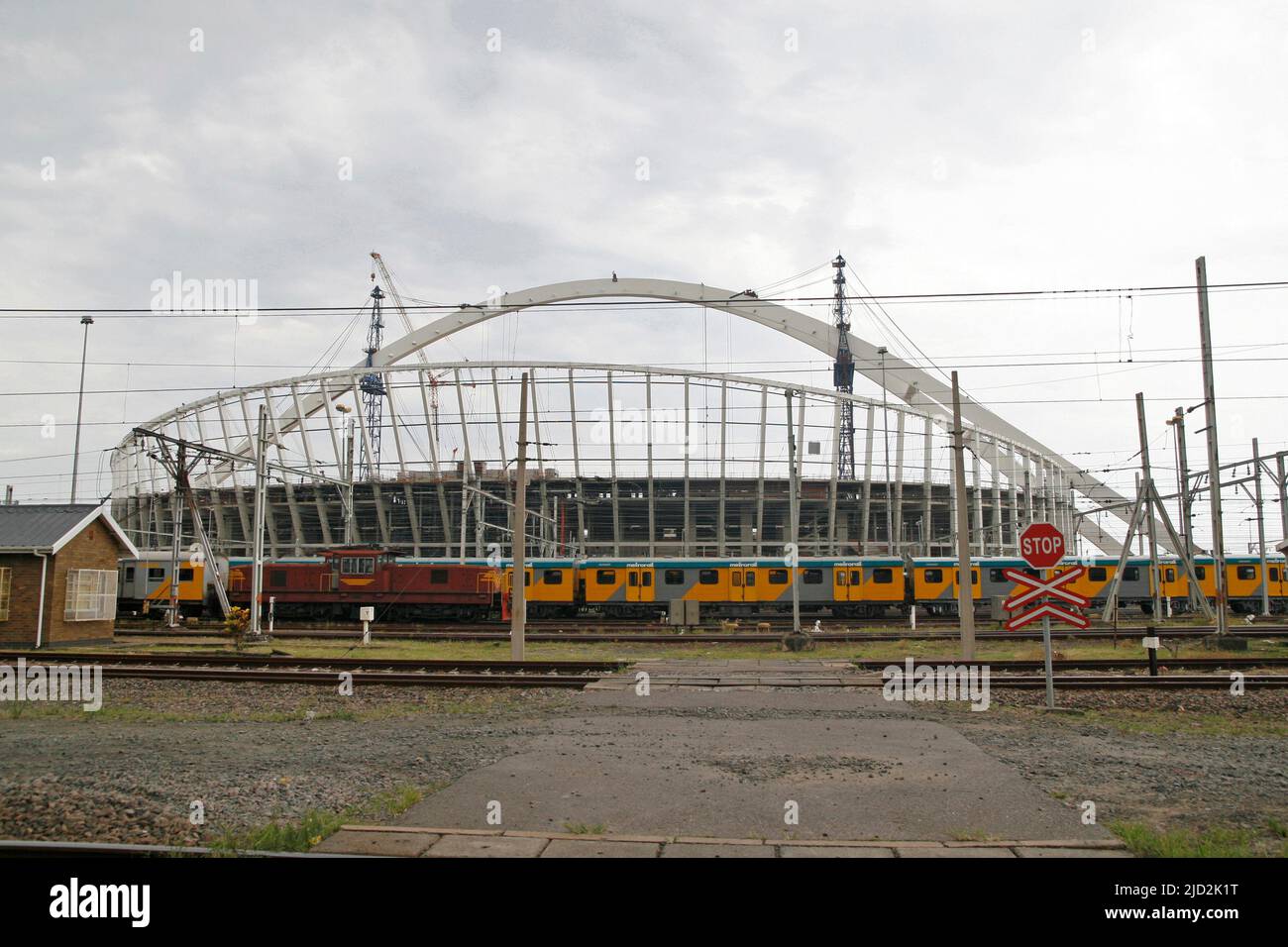 Train tracks and the construction site of Moses Mabhida Stadium, Durban, KwaZulu Natal, South Africa. Stock Photo