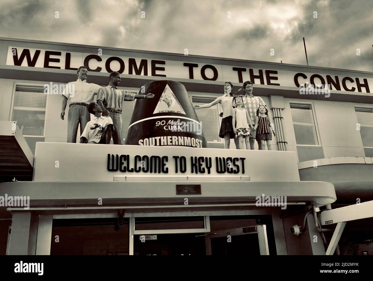 “Welcome to the Conch Republic” reads the sign on the Key West International Airport building as you enter from the tarmac.  Group of mannequins Stock Photo
