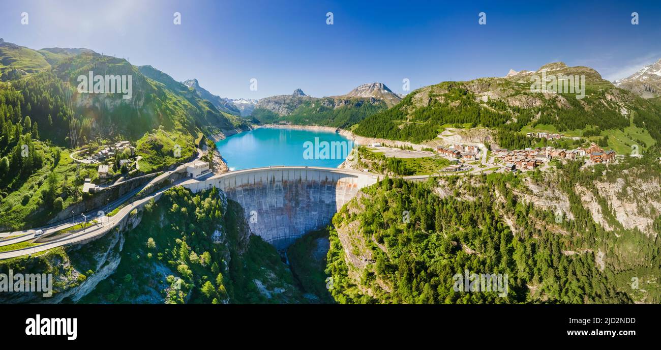Water dam and reservoir lake aerial panoramic view in French Alps mountains generating hydroelectricity. Low CO2 footprint, decarbonize, renewable ene Stock Photo