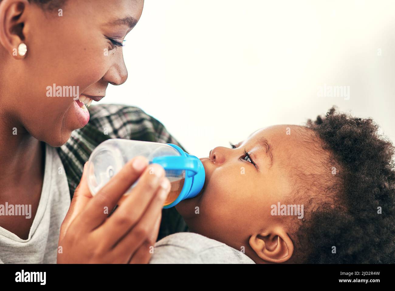 You like that, dont you. Shot of a mother giving her little baby boy a bottle. Stock Photo