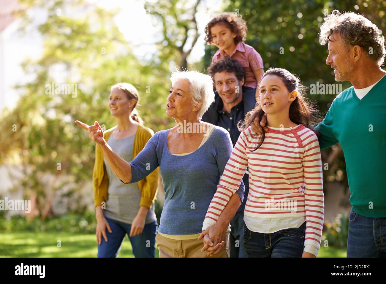 Family gathering. Shot of a family walking together outside in the garden. Stock Photo