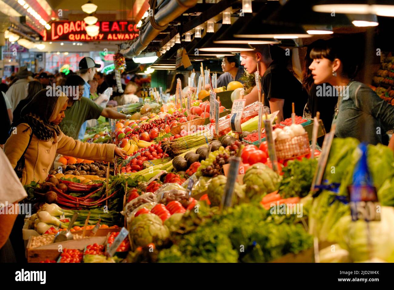 Customer inspects fresh produce at the Pike Place Market. Stock Photo