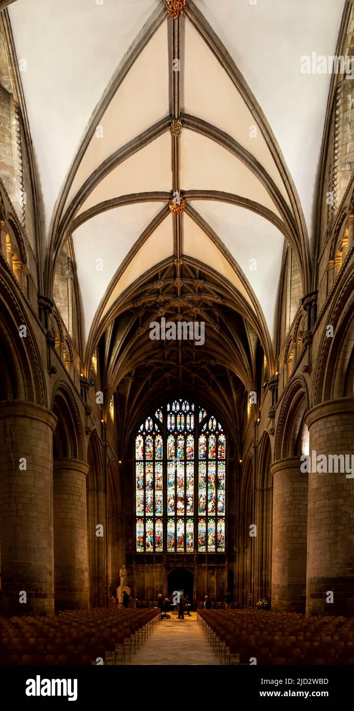 The nave with view of the soaring vaulted ceiling and stained-glass west windows, Gloucester, Cotswolds, Gloucestershire, England, United Kingdom. Stock Photo