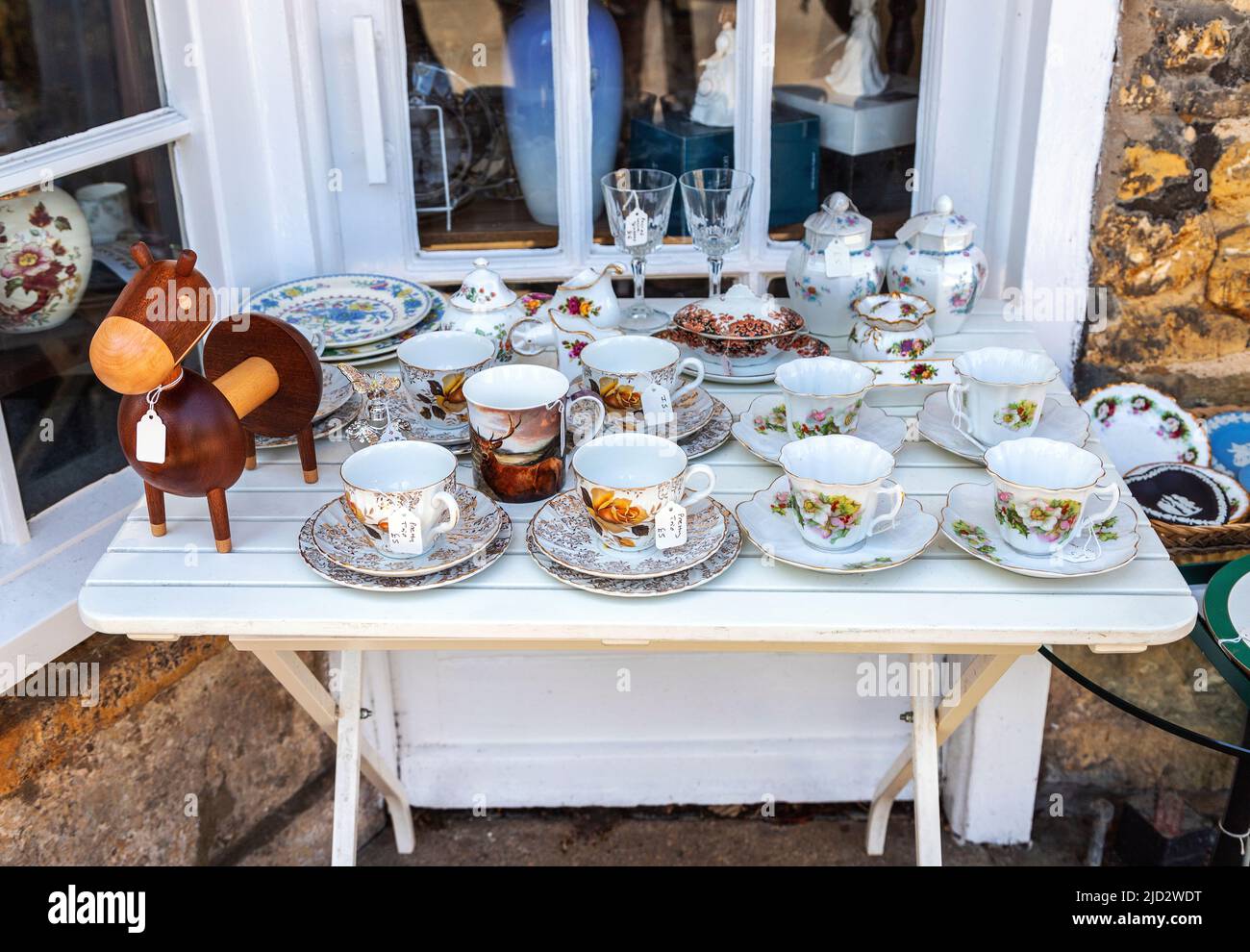 Outdoor display of second hand crockery, etc. for sale in Bourton-on-the-Water, Cotswolds, Gloucestershire, Midlands, England, United Kingdom. Stock Photo