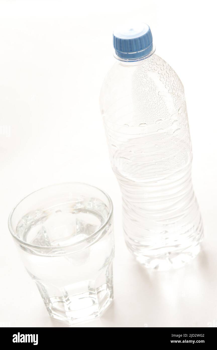 Bottled water served in a glass tumbler with the half full capped