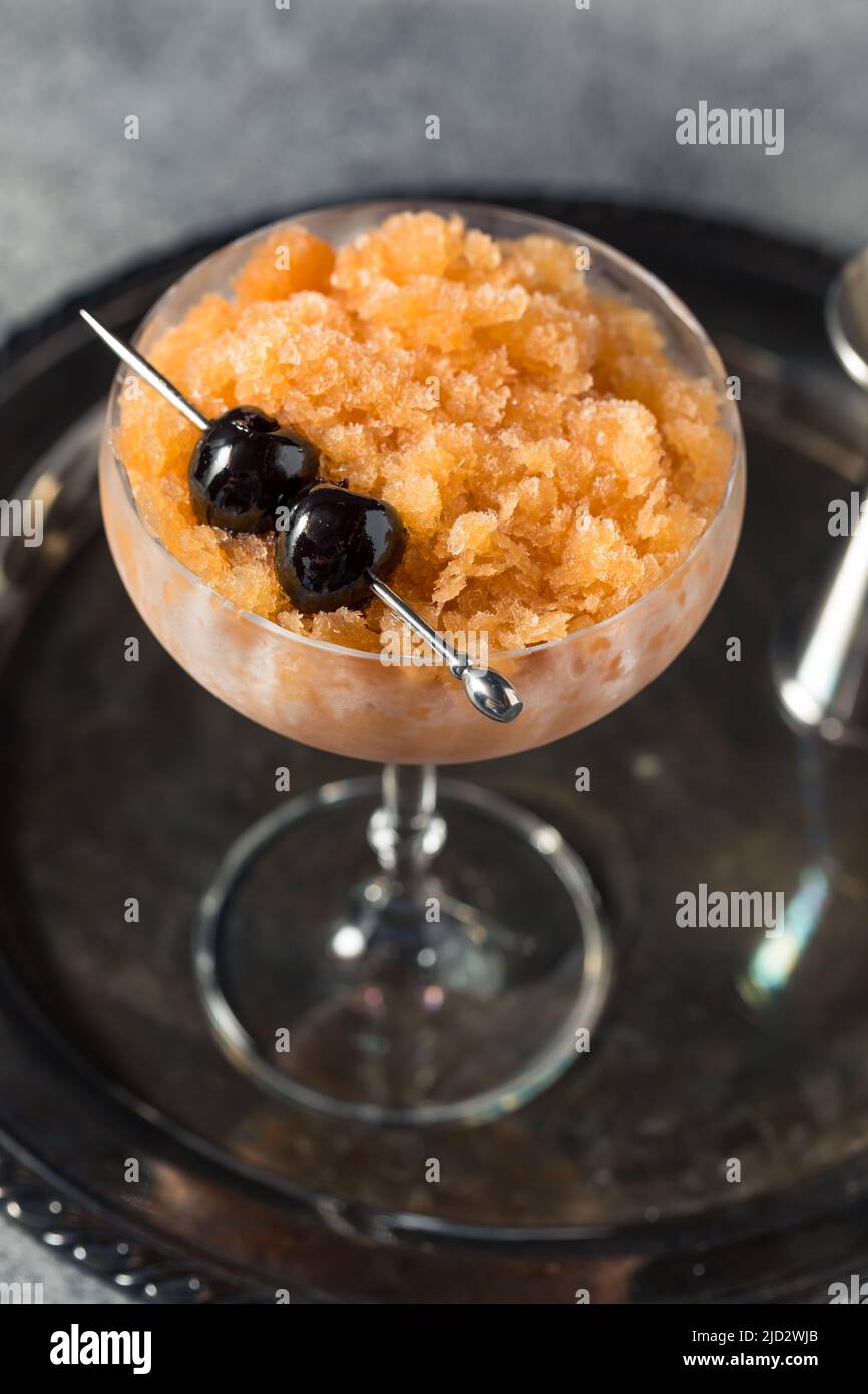 Boozy Frozen Manhattan Slushie Cocktail with Bourbon and Cherries Stock
