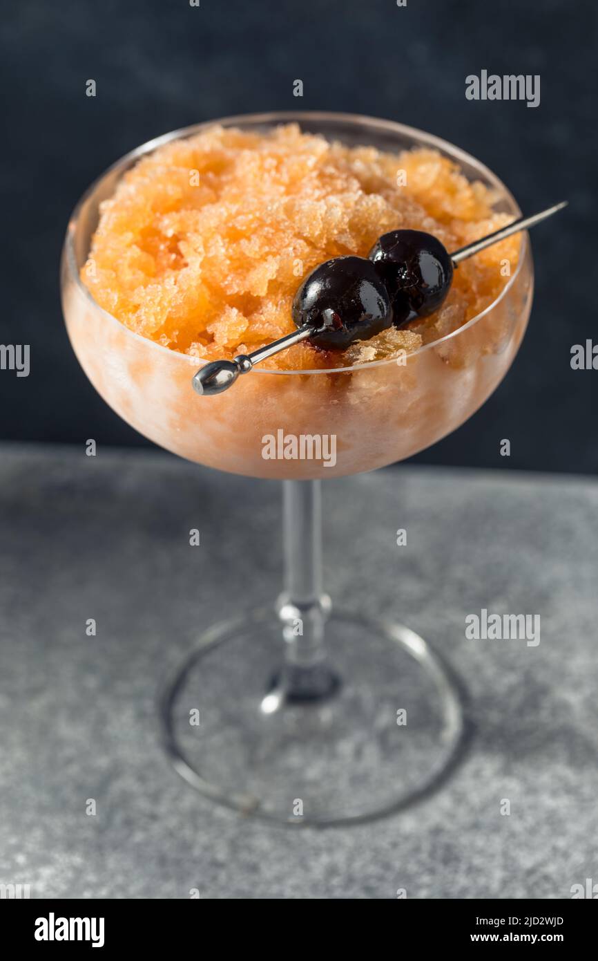 Boozy Frozen Manhattan Slushie Cocktail with Bourbon and Cherries Stock