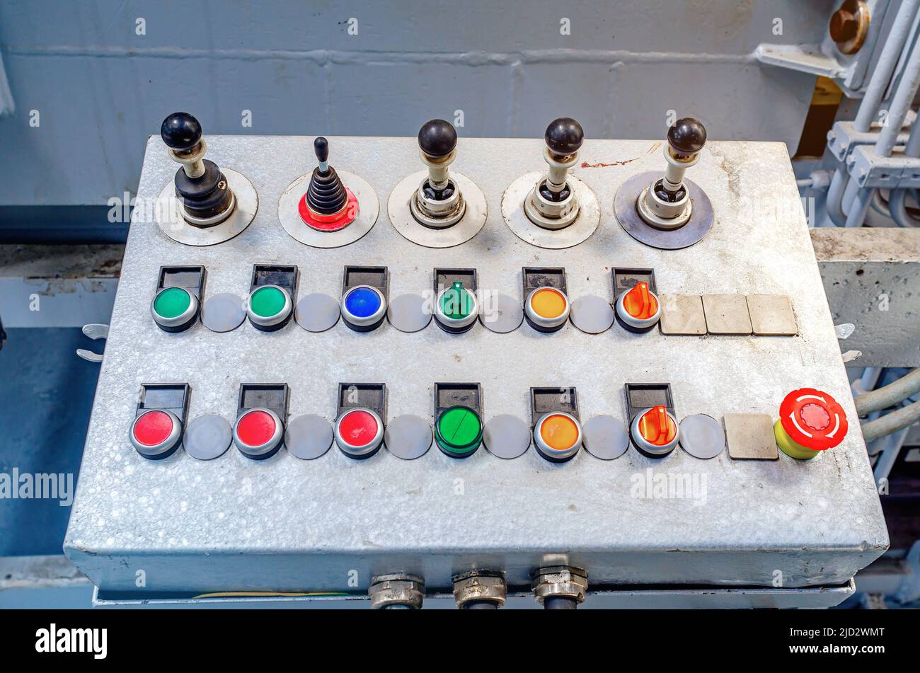 Control panel for machine. Production background. Buttons, toggle levers. Stock Photo
