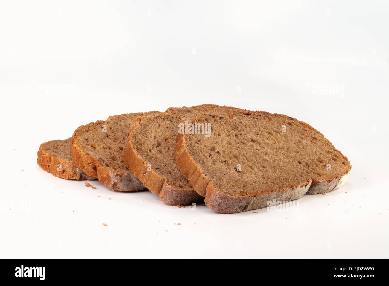 Slices grain bread isolated on bright background. Close up view. Stock Photo