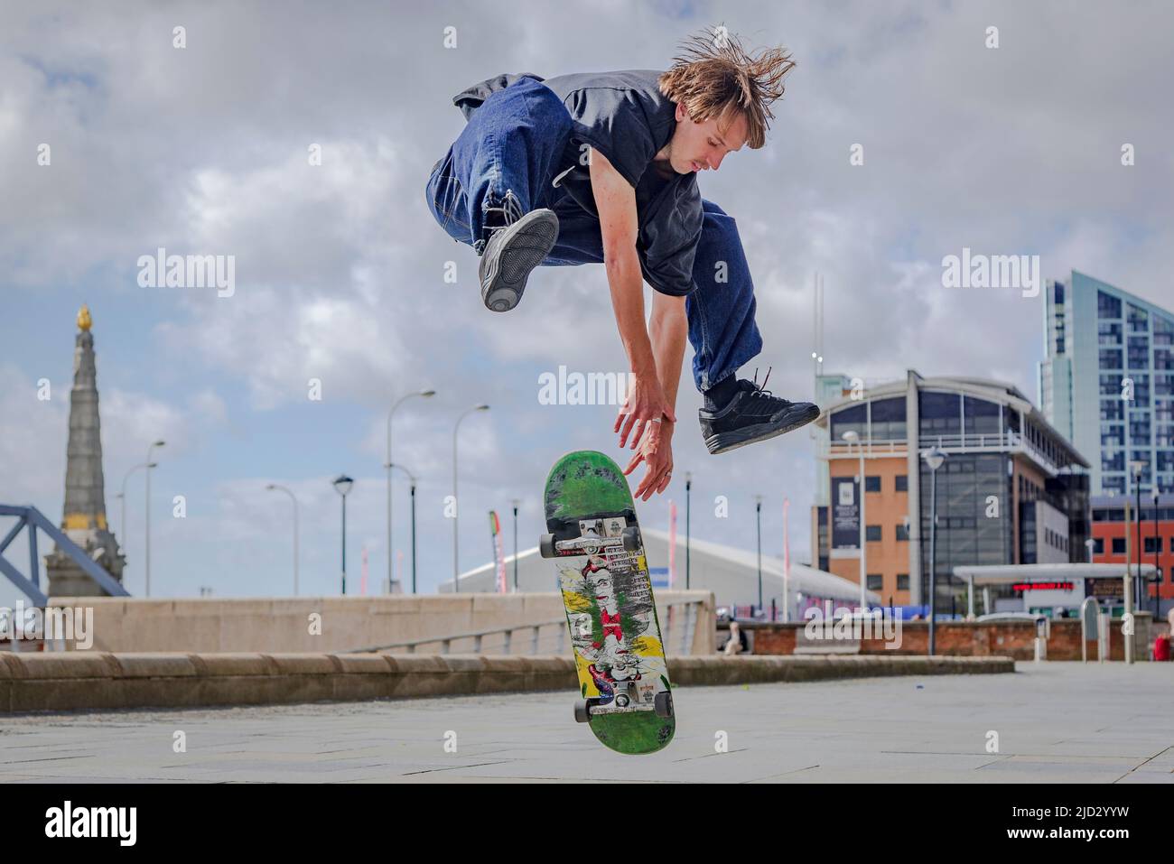 Skateboarder leaps high at Liverpool Pierhead plateau. Stock Photo