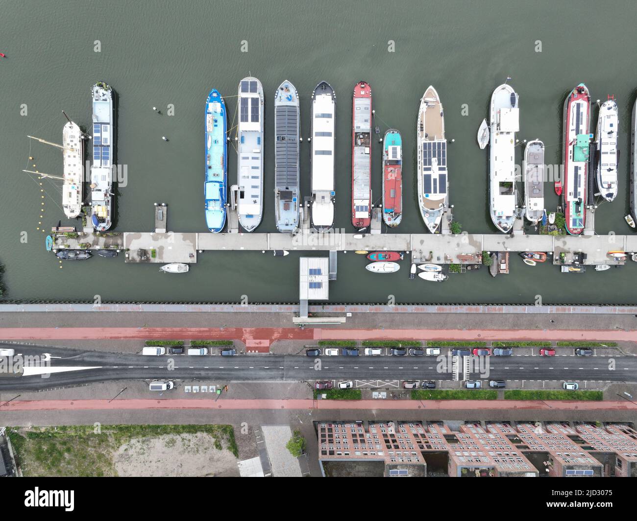 Inland vessel houseboat residential function living on a ark or ship housing pier dock village. Overhead aerial drone overview. Historical non movable Stock Photo