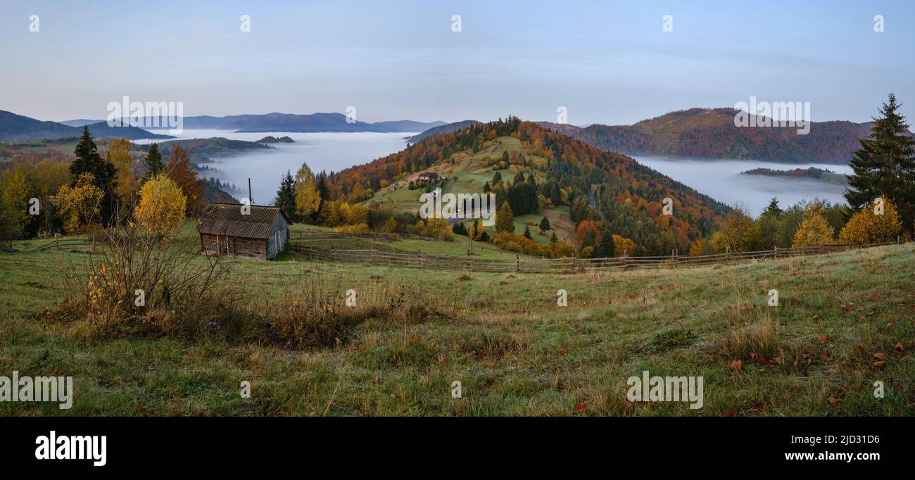 Foggy early morning autumn mountains scene. Peaceful picturesque traveling, seasonal, nature and countryside beauty concept scene. Carpathian Mountain Stock Photo