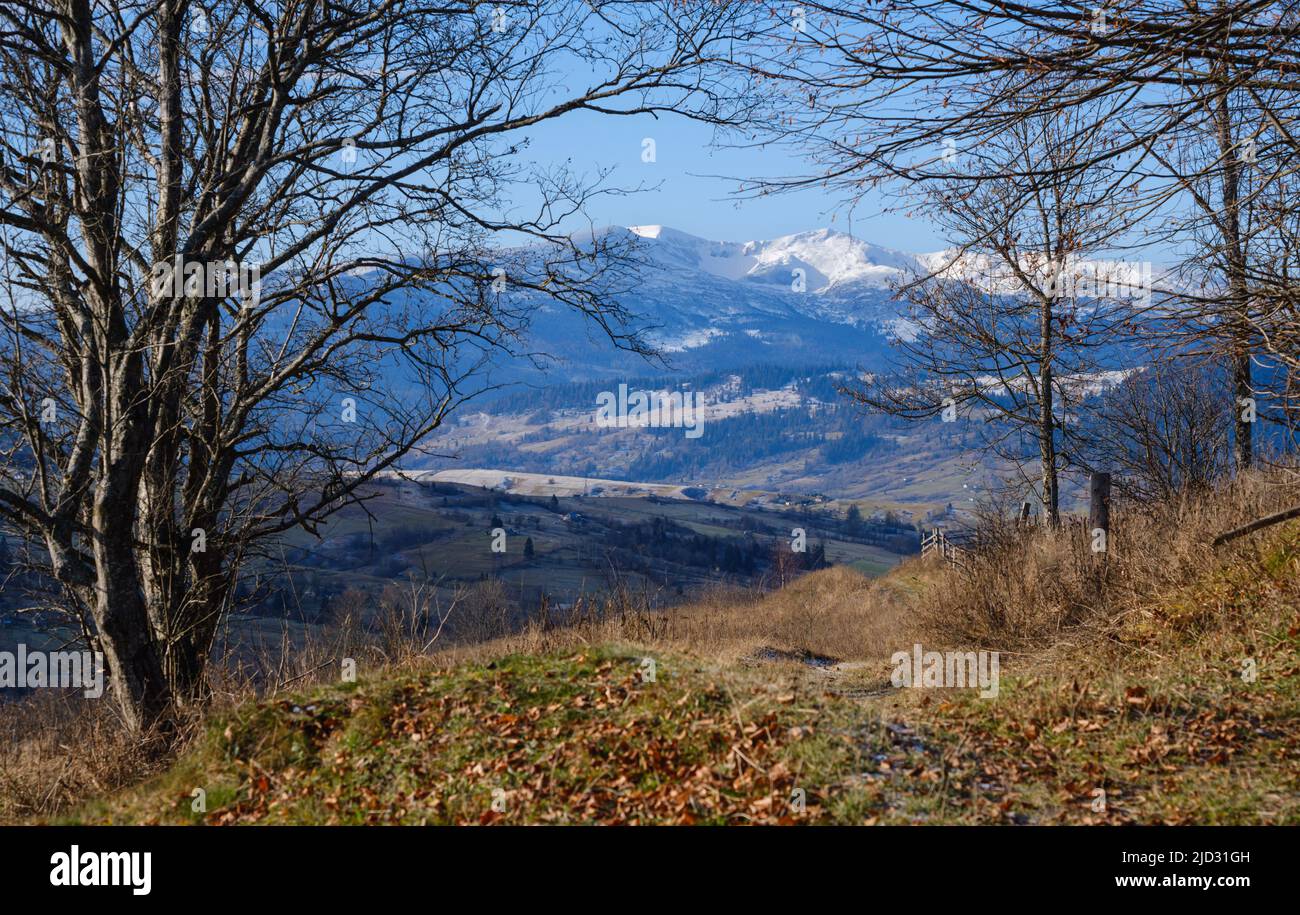 Last good weather days in autumn mountain countryside morning peaceful picturesque scene. Ukrainian Carpathians mountains in far. Stock Photo