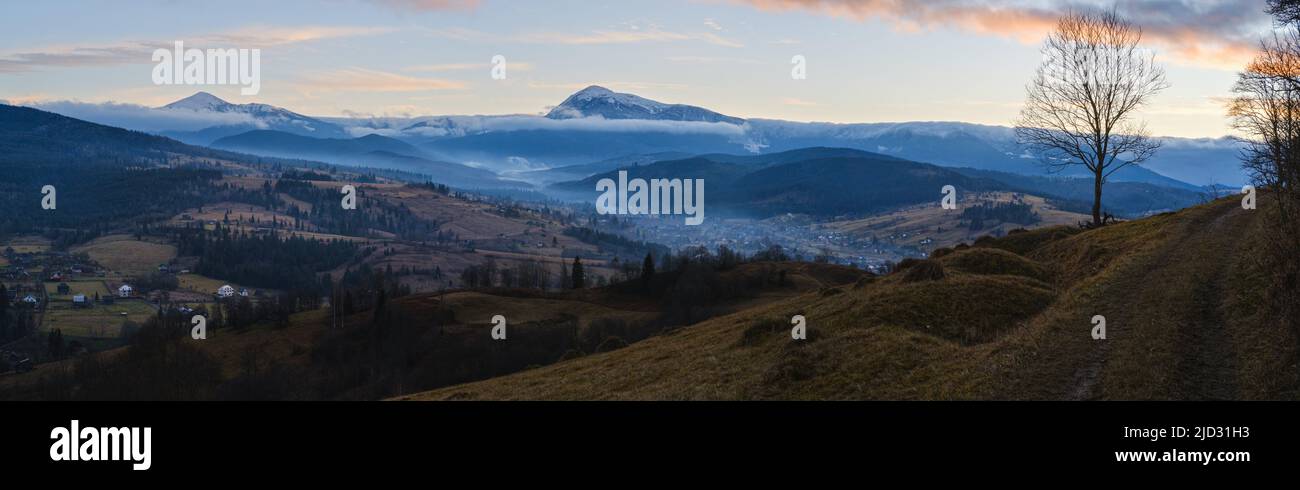 Picturesque pre sunrise morning above late autumn mountain countryside. Ukraine, Carpathian Mountains, Hoverla and Petros tops in far. Stock Photo