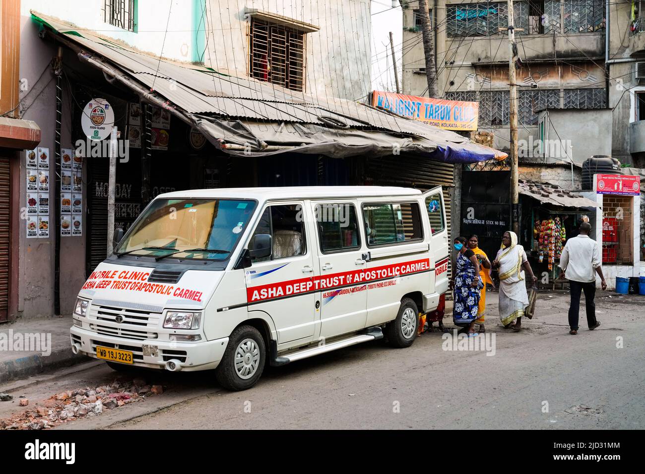 a Catholic sister counsels poor people from a slum on health issues at the Asha Deep Trust's Mobile Clinic in Kolkata, India Stock Photo