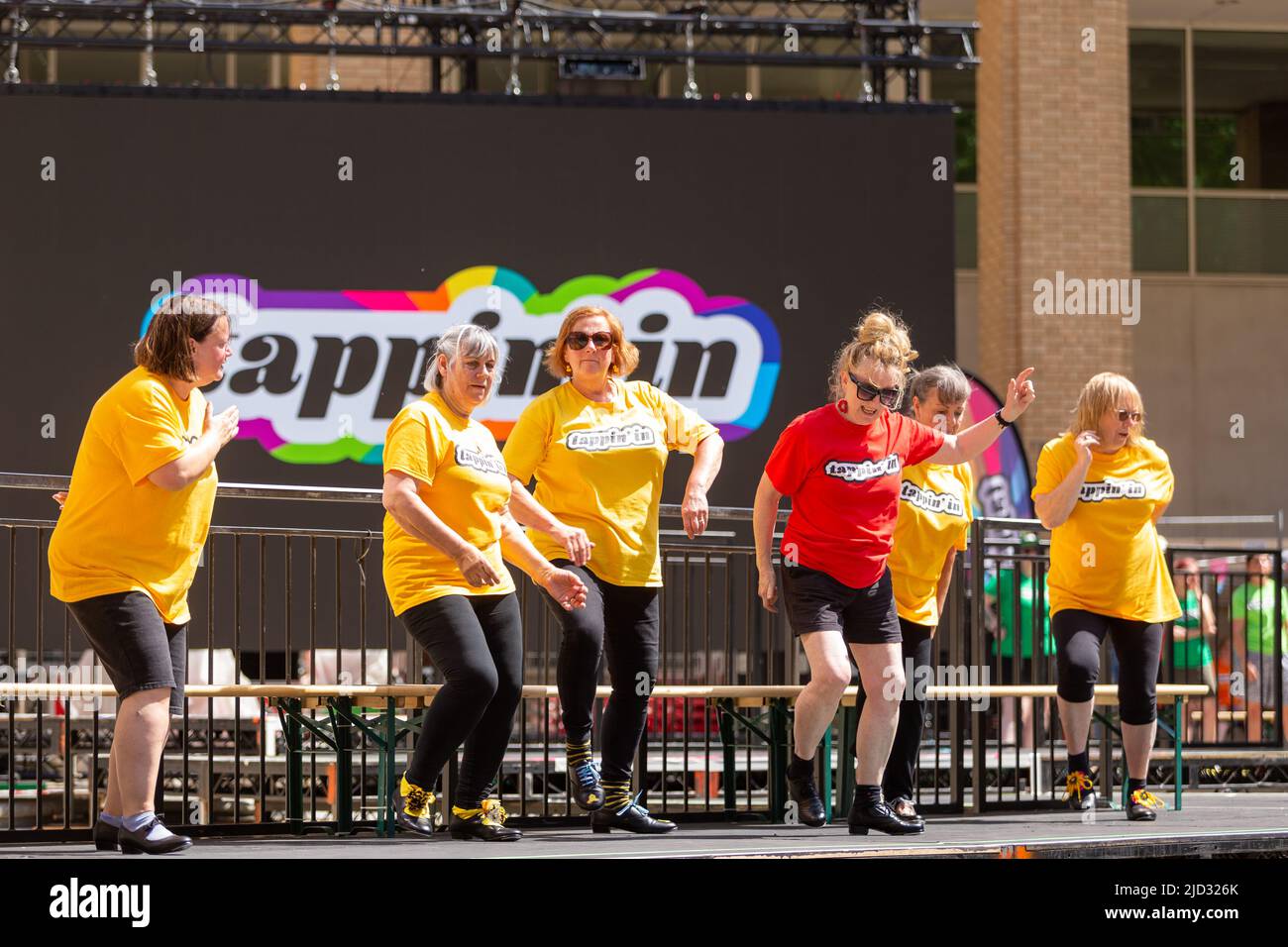 Amateur tap dancers performing in public in a summer dance festival, UK